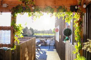 an outdoor deck with a pergola covered in ivy at Royal Hotel in Forfar