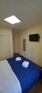 a room with a large blue bed with towels on it at B&B Omnia Scilla in Scilla +22 photos