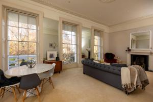 a living room with a couch and a table at Pittville House in Cheltenham