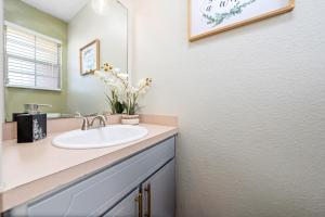 a bathroom with a sink and a mirror at Home Away From Home with King Bed, WiFi and Lots of Amenities in Killeen +21 photos