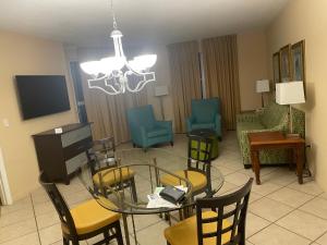 a living room with a glass table and chairs at Vacation Village in Weston