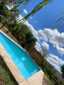 a swimming pool with the sky in the background at Munay EcoHostal - Cabañas de Adobe in Tinogasta