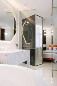 a bathroom with a sink and a mirror at Luxurious Mamu Apartment in Batumi