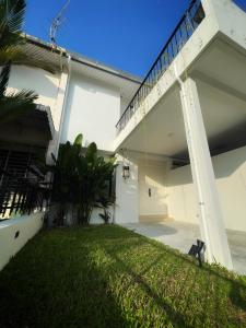 a view of the back of a house with a yard at Designer Guesthouse Pulau Tikus & Gurney Drive, Georgetown, Penang in George Town