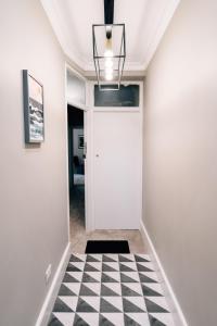 a hallway with a black and white checkered floor at Sanctuary-by-Sea in Worthing