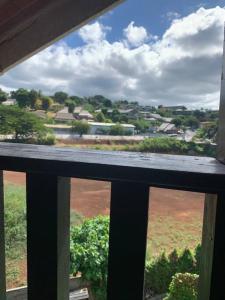 a balcony with a view of a field and a town at Appart des airs Mamoudzou in Mamoudzou