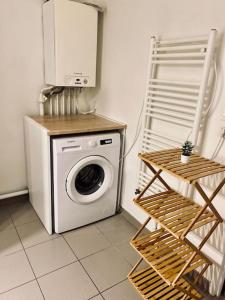 a washer and dryer in a room with at Charmant T2 moderne /proximité CDG / Confort in Villepinte