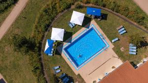 an overhead view of a swimming pool with umbrellas at BEECH Resort Boltenhagen in Boltenhagen