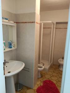a bathroom with a sink and a toilet at Terrace Home in Saint Vincent