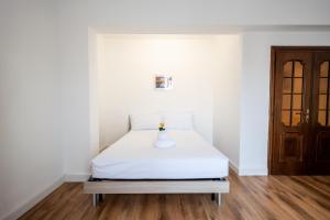a white bed with a vase on it in a room at ShortMi Balilla in Milan