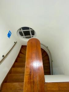 a spiral staircase with a window on the ceiling at Viva Chile Providencia - Bustamante in Santiago