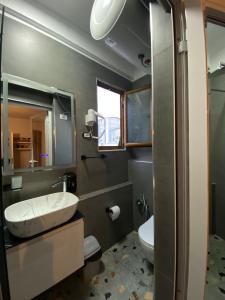 a bathroom with a sink and a toilet at What's Up Tirana in Tirana +26 photos