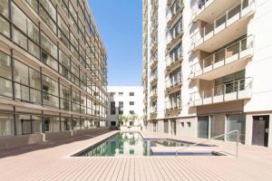 a building with a pool in the middle of a courtyard at ICON Living in Cape Town