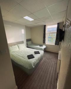 a hotel room with a bed and a couch at PRESTIGE PLAZA Hotel in Blackpool