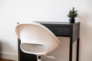 a white chair sitting next to a black desk at ShortMi Balilla in Milan