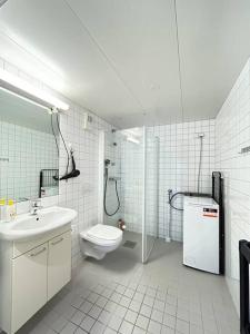 a white bathroom with a toilet and a sink at Luxurable super central 3 BR apt for a family of 6 in Oslo in Oslo