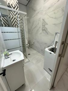 a white bathroom with a sink and a mirror at Rambla Alicante in Alicante