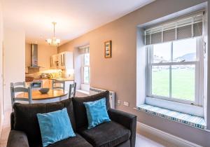 a living room with a couch and a large window at Flat 1, Literary Institute in Richmond