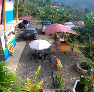 a table and chairs and an umbrella in a yard at Casa Viva Alojamiento Rural in Jardin