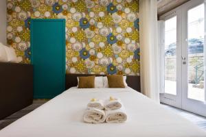 um quarto com uma cama com toalhas em Aposentus - St Francisco Studio 20 no Porto