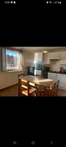 a kitchen with a table and chairs in a room at Panoramic Harbour View Apartment in Oban
