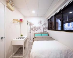 a bedroom with two beds and a window at Pillows CoLiving in Hong Kong