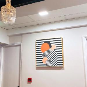 a painting of a woman on a wall at Pillows CoLiving in Hong Kong