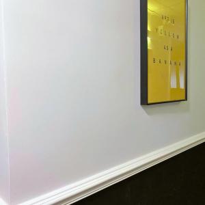 a white wall with a picture on the wall at Pillows CoLiving in Hong Kong