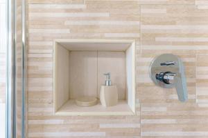 a bathroom with a toilet in a box on a wall at exclusive use swimming pool available from June to September in Cagliari +45 photos