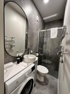 a bathroom with a sink and a toilet and a mirror at Ladies Group apartments Palanga Mano jūra 2 apartamentai 74G-2 in Palanga