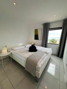 a bedroom with a large bed and a window at Achacay View Apartment in Los Cristianos