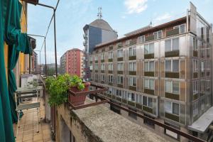 uma varanda com duas plantas e um edifício em Primopiano - Giacosa em Milão