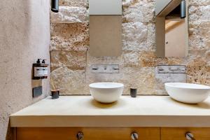 two white bowls on a counter in a bathroom at Rancho Adobe Eco Hotel in Tupungato