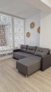 a living room with a couch and a coffee table at Lovely apartment in City Center in Timişoara