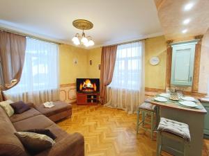 a living room with a couch and a table at Old Town Retreat with Stunning Views 2 bedroom Apartment in Riga