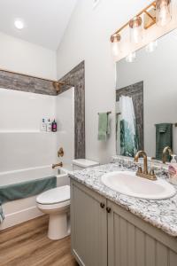 a bathroom with a sink and a toilet at The Golden Eagle Cabin in Valemount