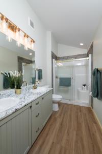 a bathroom with a sink and a toilet and a shower at The Golden Eagle Cabin in Valemount