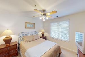 a bedroom with a bed and a ceiling fan at Seaside - Azure Dream B-302 in Virginia Beach +11 photos