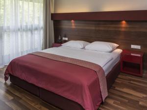 Ліжко або ліжка в номері Asia Hotel & Spa Leoben