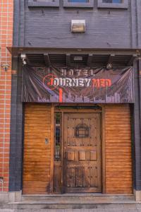 a store with two doors and a sign above them at hotel journey in Medellín