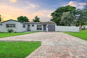 a house with a brick driveway in the yard at South Florida Splendor - Pool Home in Hollywood