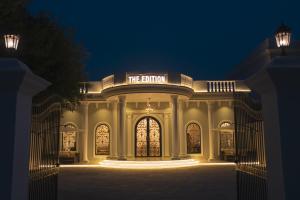 a building with a lit up entrance at night at The Edition Bahawalpur in Bahawalpur