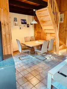 a dining room with a wooden table and chairs at Extertal-Ferienpark - Premium Ferienhaus Sauna Wandern #56a in Extertal