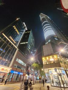 a group of tall buildings in a city at night at Pillows CoLiving in Hong Kong
