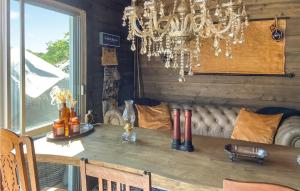 a dining room with a table and a chandelier at Amazing Home In Sturkö With Wi-Fi in Sturkö