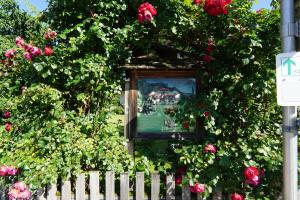 a fence with a picture of a bush with roses at Landhaus Weiß in Bad Reichenhall