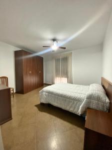 a bedroom with a bed and a ceiling fan at Casa Cruz de Marbella Luque in Luque +15 photos