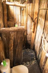a bathroom with a toilet in a bamboo house at Coco House in Buenaventura