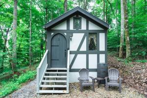 a small shed with two chairs and a staircase at Tiny Home Cottage Near the Smokies #2 Lotte in Sevierville