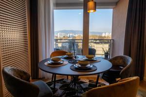a table and chairs in a room with a window at The Dome in Zagreb